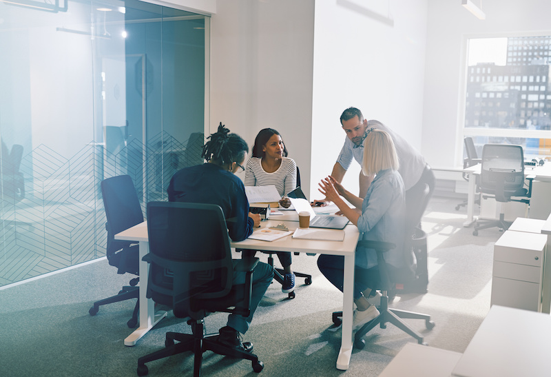 people working in a glass office